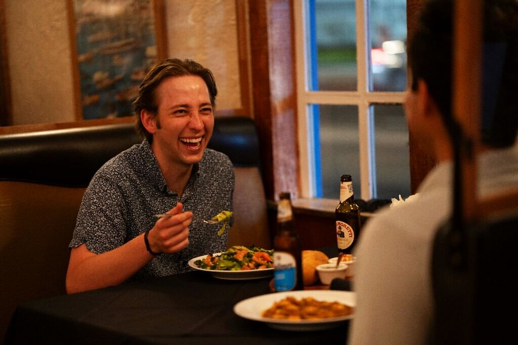 Friends enjoying fresh pasta and empanadas together at Pasta Connection