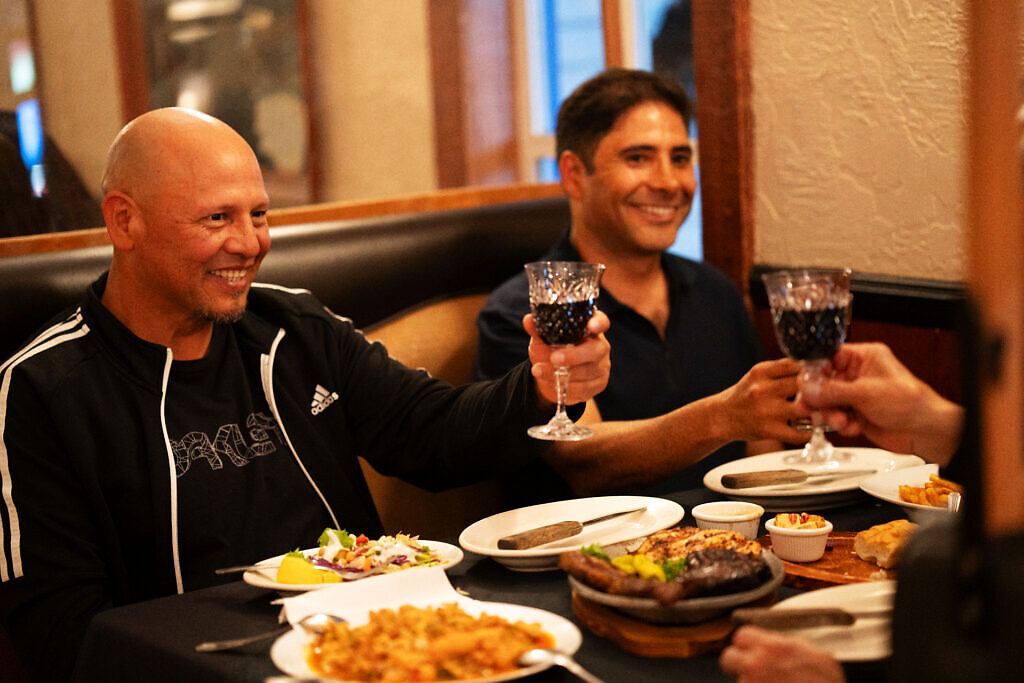 Friends sharing a meal at Pasta Connection in Costa Mesa