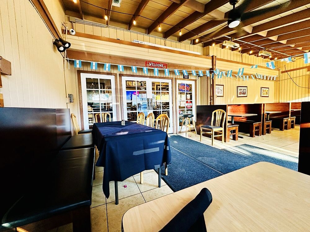 Inside Pasta Connection, the welcome entrance with Argentine flag bunting and booth seating